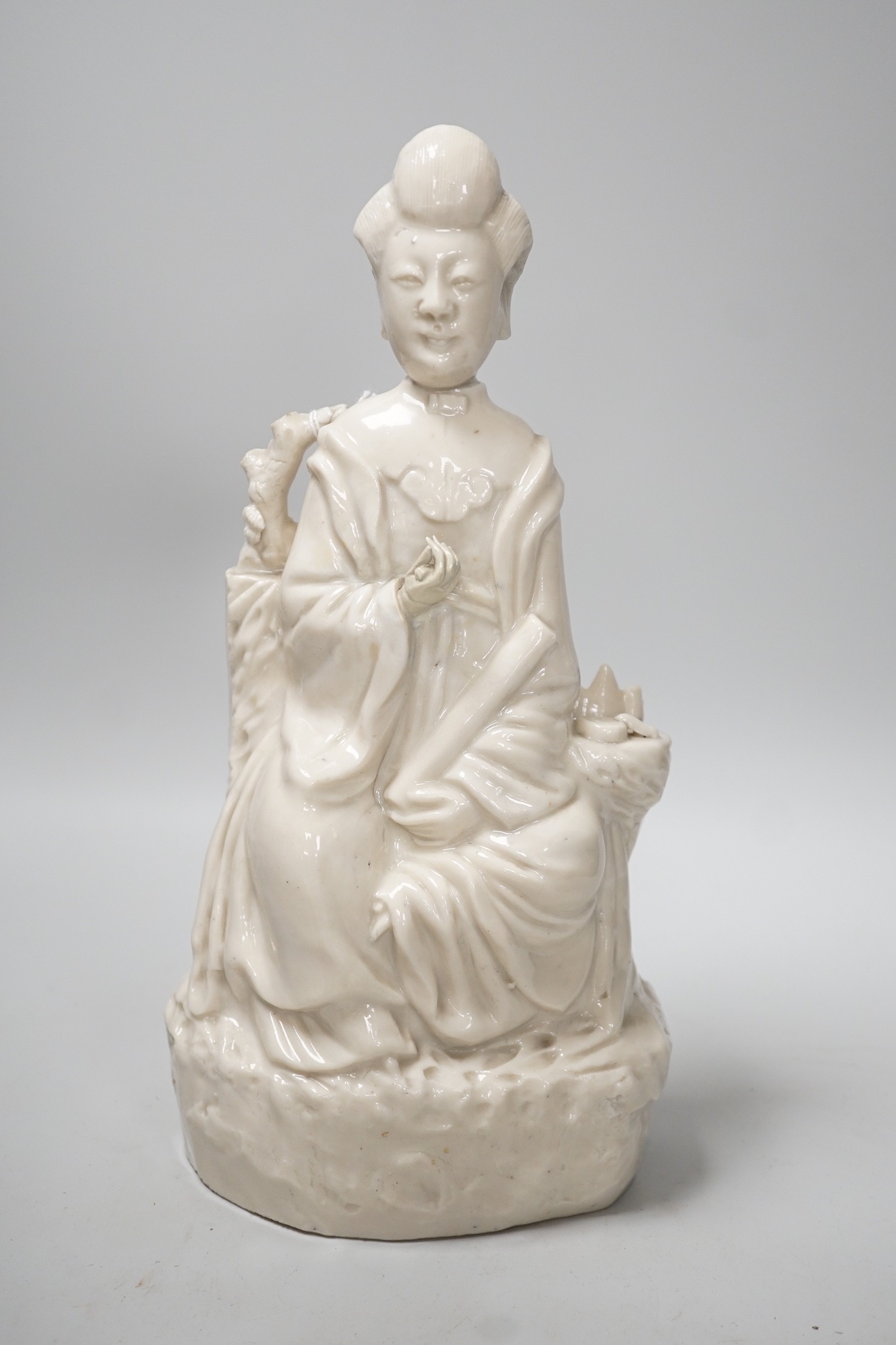 A Chinese enamelled blanc de chine figure of Guanyin, together with three other figures. 28cm tall